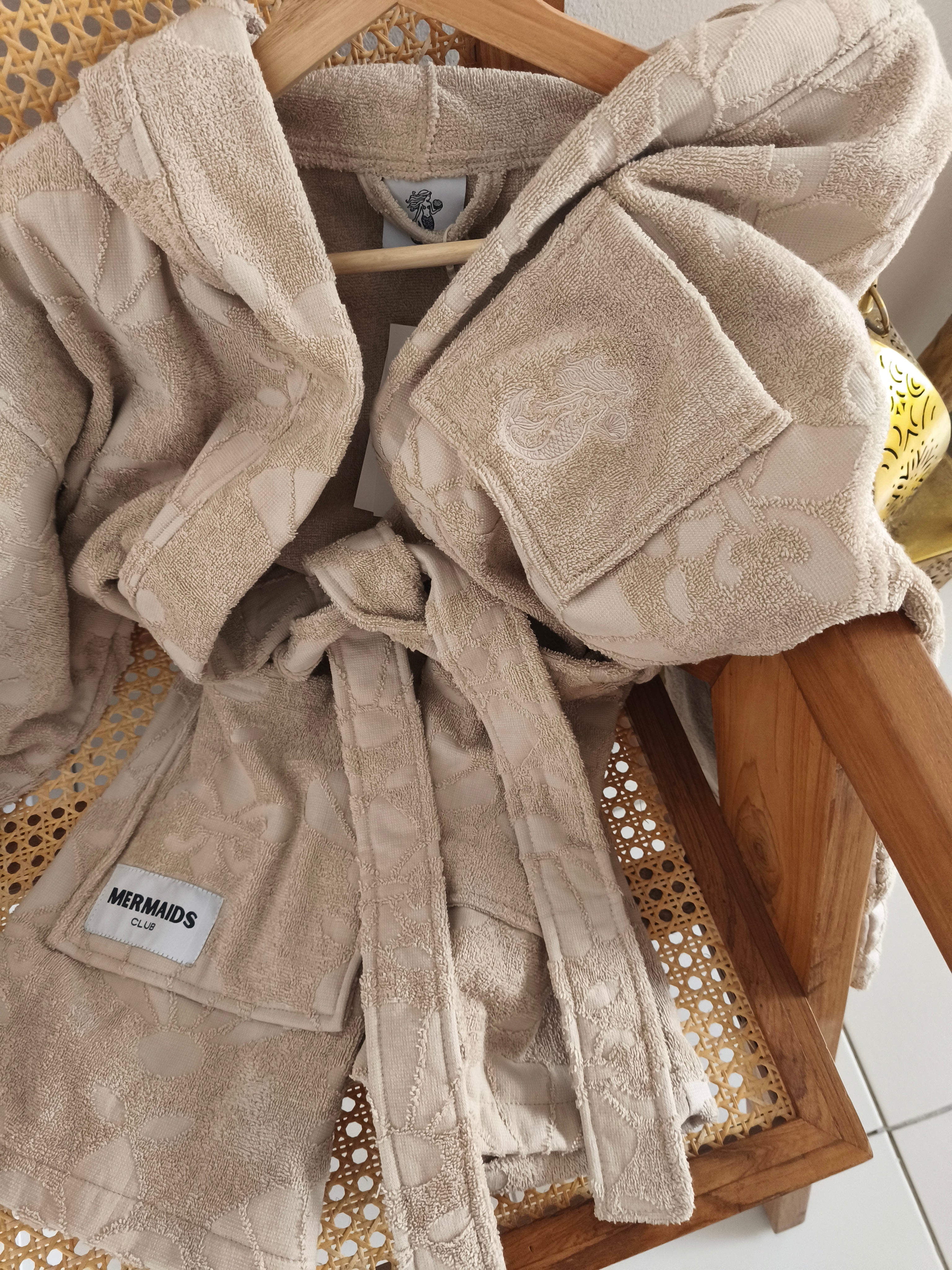 Milky sand robe details front Dubai pool - Mermaids Club